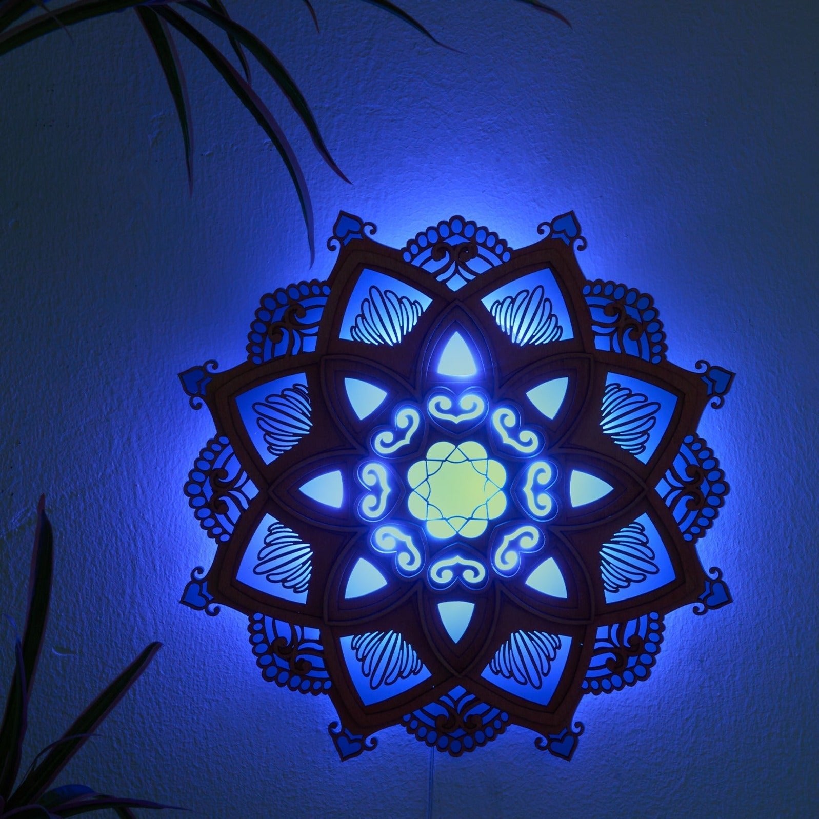 Lotus Mandala Yoga Wall Lamp glowing blue, natural wood design enhancing peaceful yoga and meditation spaces.