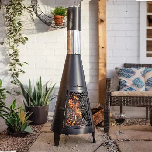Modern Mesh Chiminea Fireplace with wood fire burning, stylish outdoor patio heating solution in cozy garden setting
