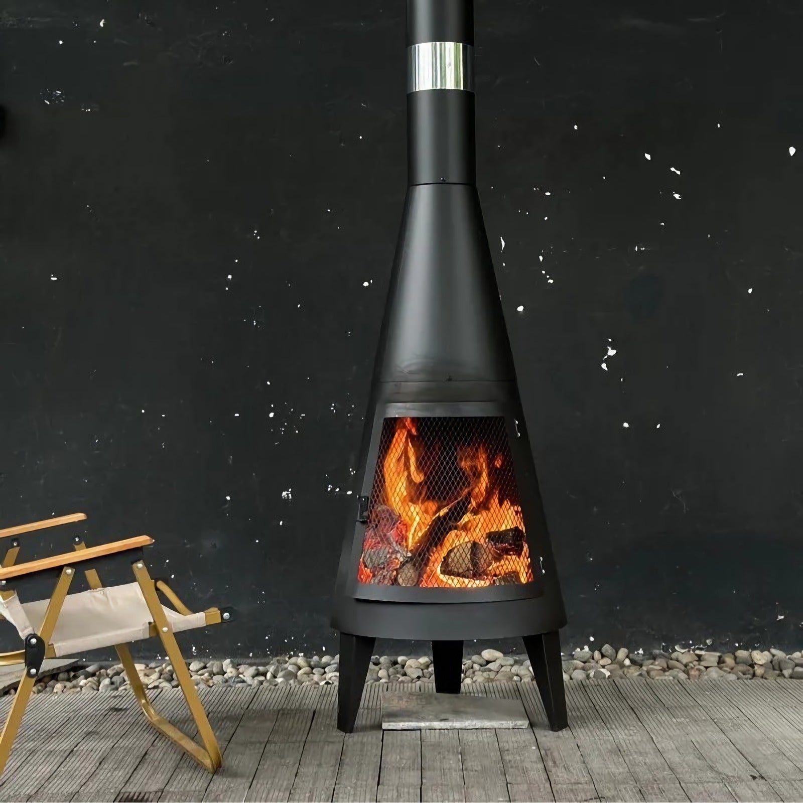 Modern Mesh Chiminea Fireplace with crackling wood fire shaping a warm, stylish outdoor ambiance on a patio.