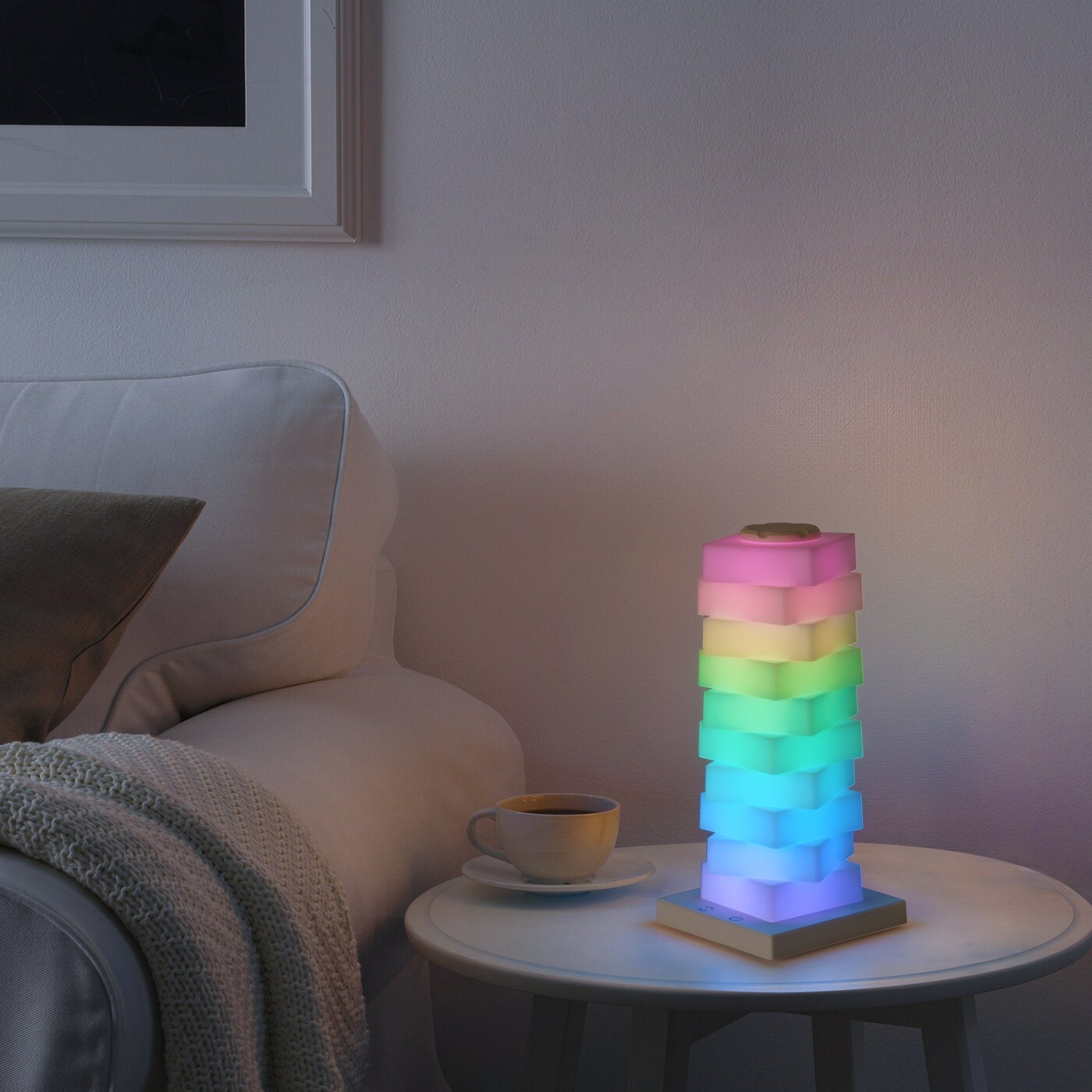 Modular Rotating Touch RGB Lamp glowing in vibrant colors on a side table, perfect for creative ambiance.