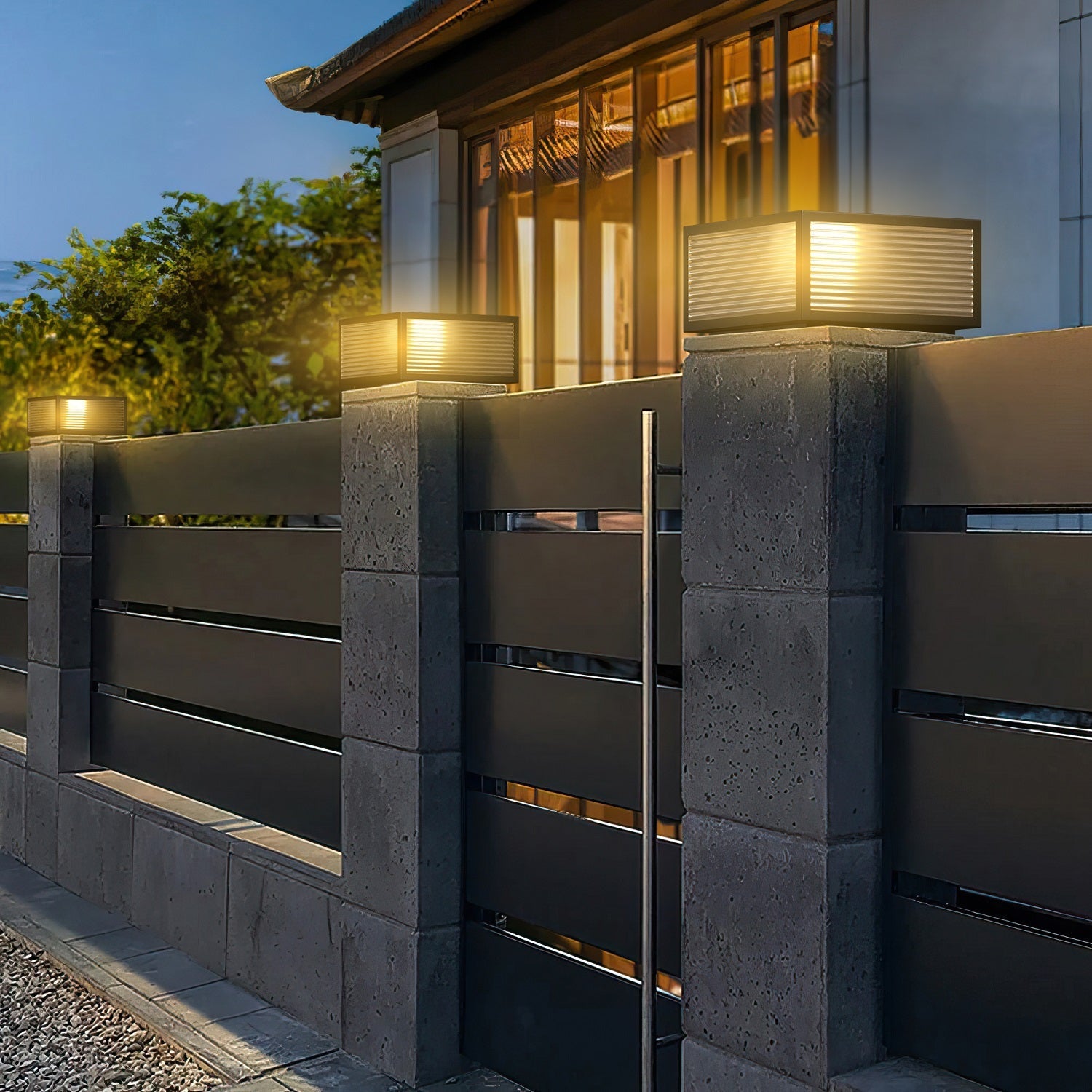 Outdoor Solar Powered Post Cap Lights illuminating fence pillars with warm, elegant, durable metal and glass design.