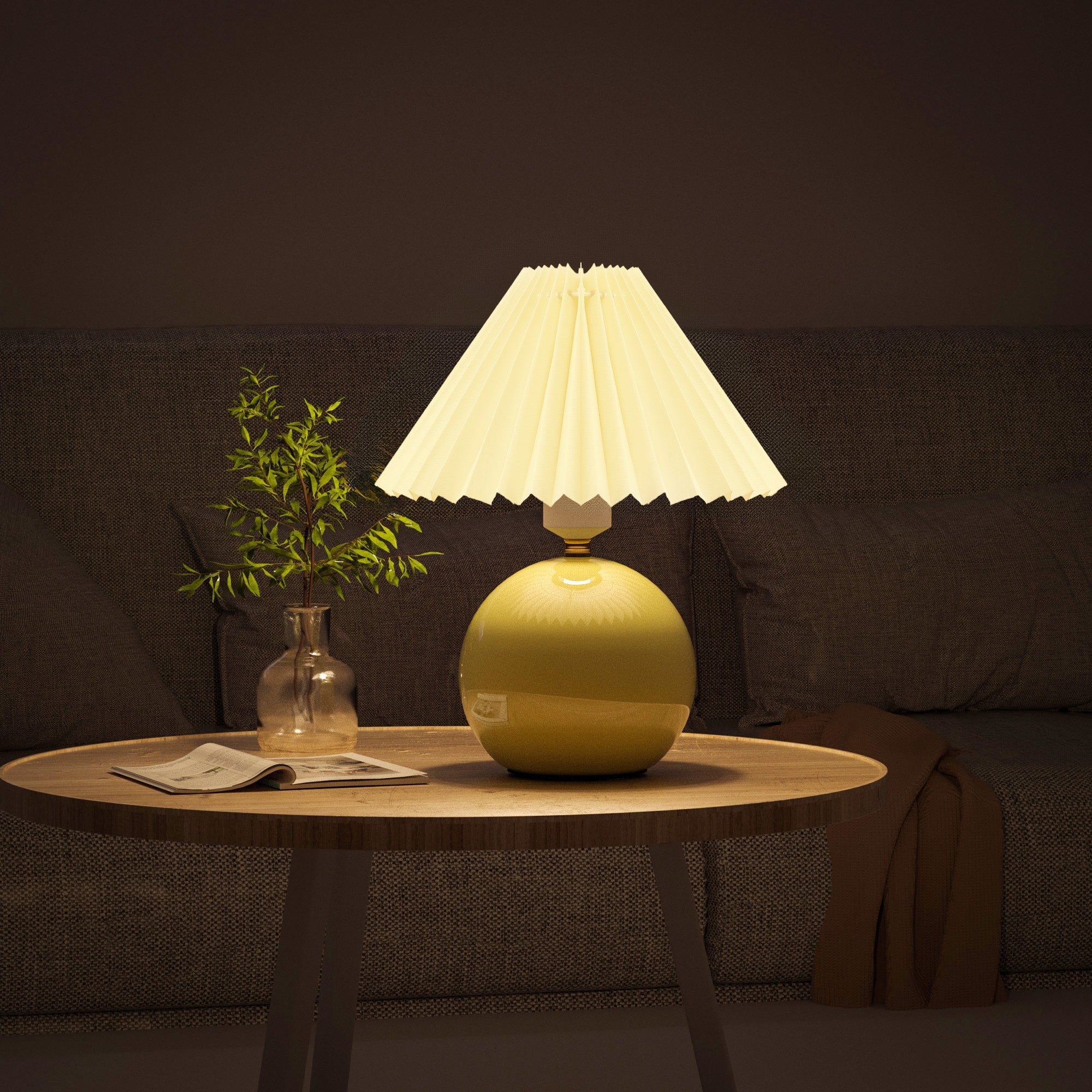 Pottery Ceramics Table Lamp with glowing fabric shade on wooden table, adding warm ambiance to modern living room.