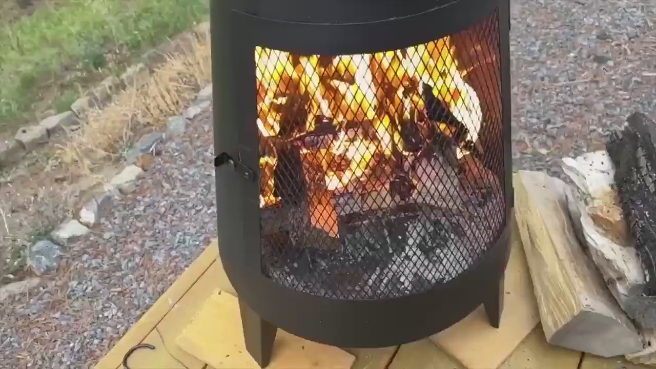 Load video: Modern mesh chiminea fireplace with 360-degree fire visibility, placed outdoors for heating and decorative ambiance