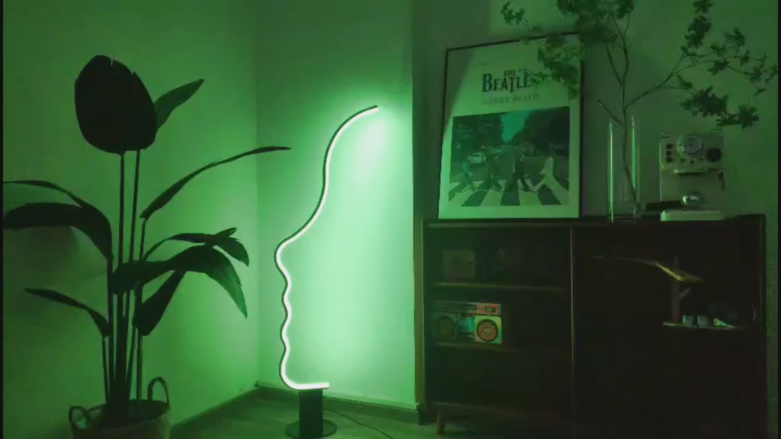 Load video: Edward Visage RGB lamp with face-shaped design and colorful lighting, used as modern decorative accent lighting
