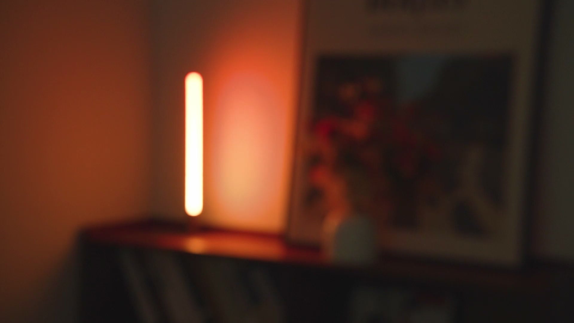Load video: RGB corner table lamp with 360 million color options, app and voice control, lighting up a modern tabletop setting