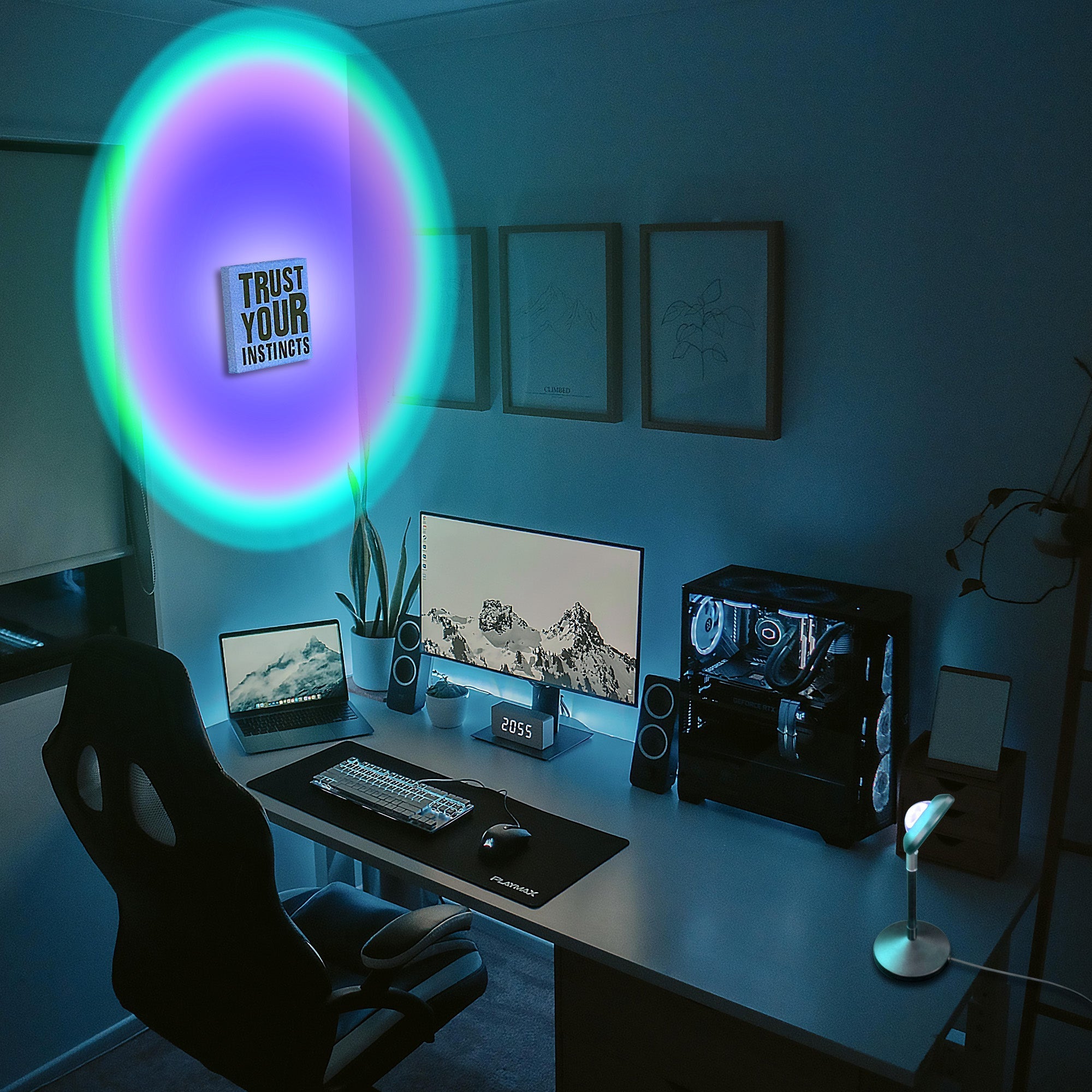 RGB Sunset Projector Lamp casting vibrant colorful light in a modern gaming and work setup room ambiance.