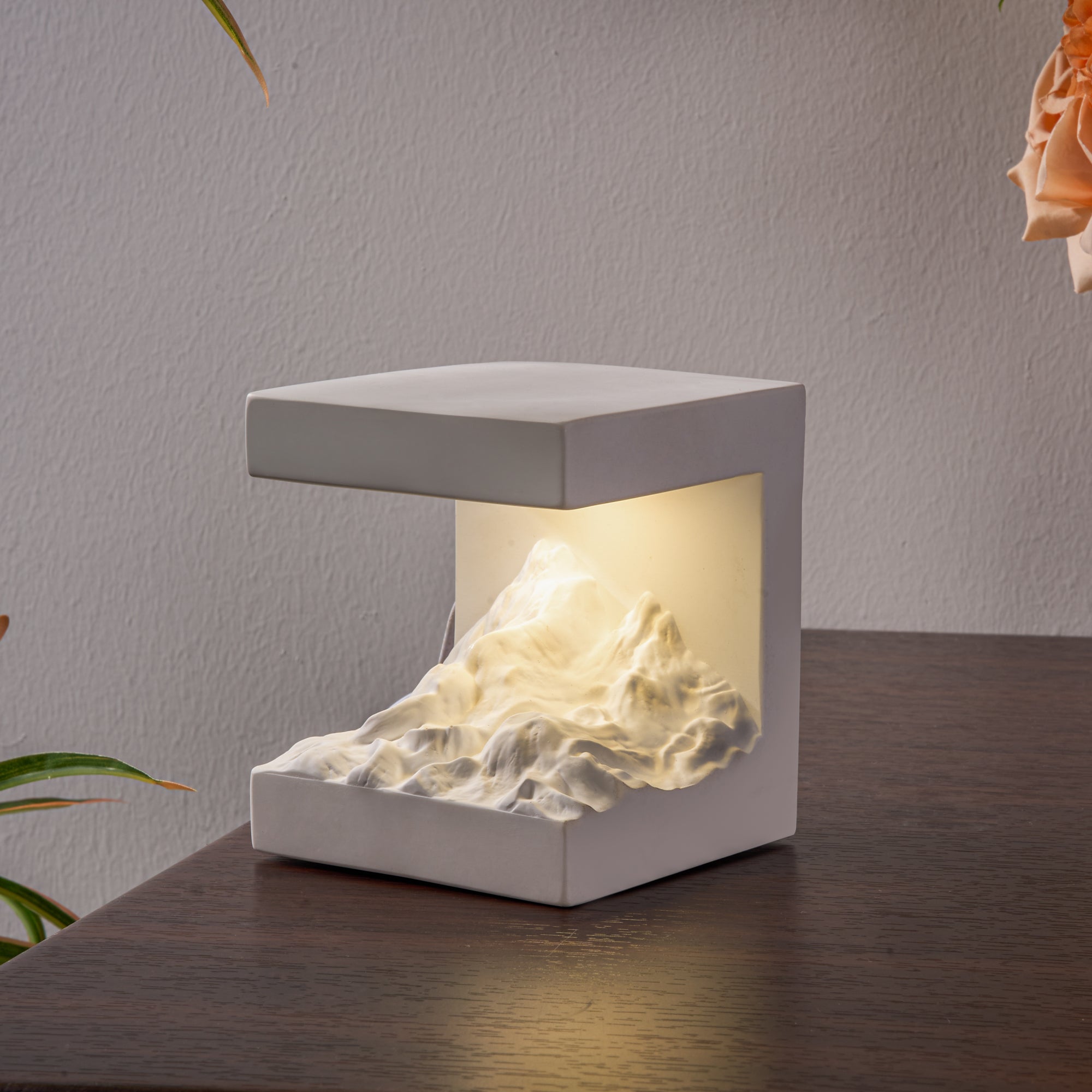 Snow Mountain Night Light & Diffuser Stone showing warm illuminated mountain sculpture on a wooden desk.