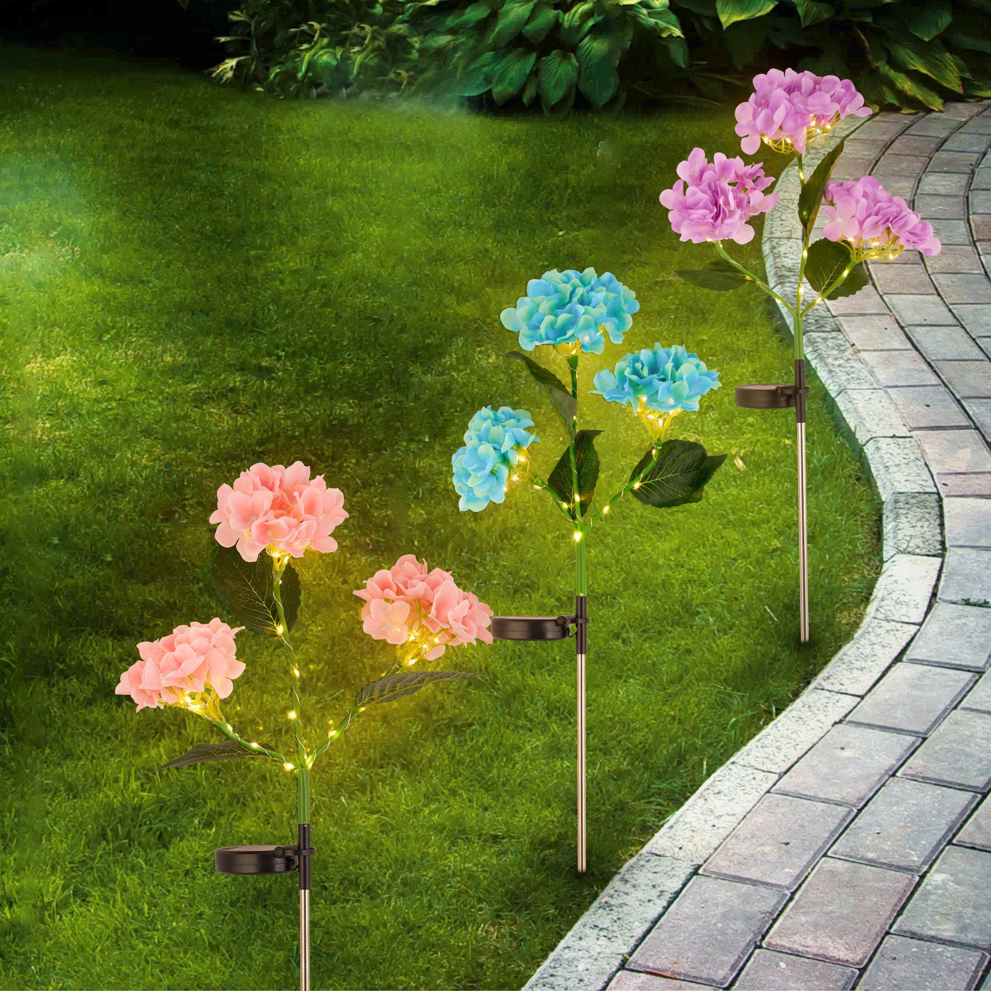 Solar Powered Hydrangea Pathway Light with colorful flowers and soft LED glow lining a garden walkway.