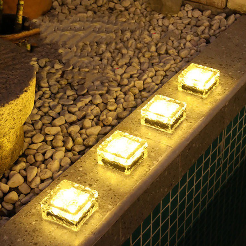 Solar Powered Ice Bricks Path Lights, 6 Pack glowing warmly along a poolside edge, enhancing outdoor ambiance.