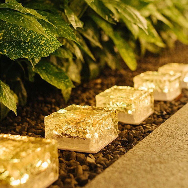 Solar Powered Ice Bricks Path Lights 6 Pack glowing along garden path, energy-efficient and easy to install.