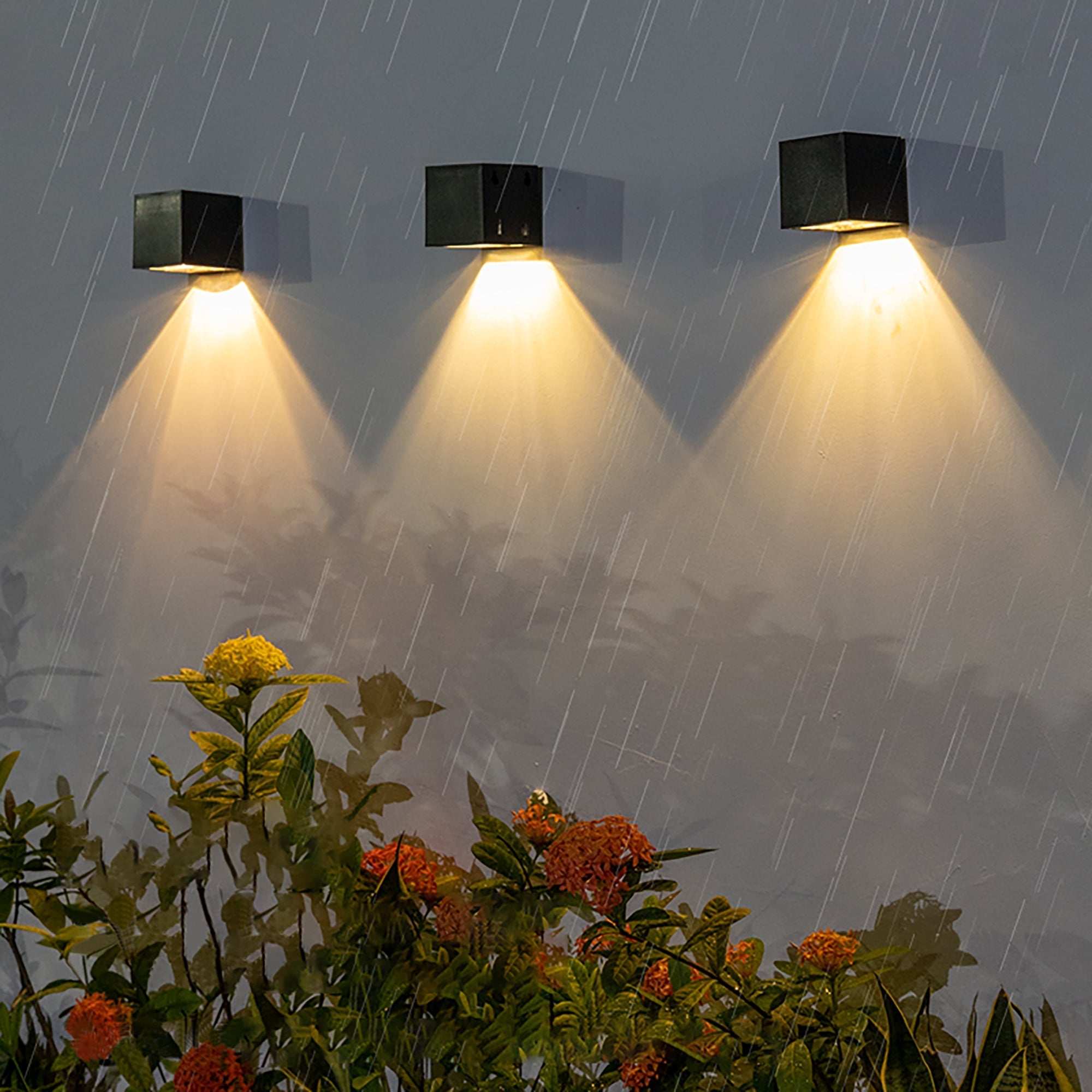 Solar Powered Outdoor Landscape Wall Lights shining in rain, illuminating garden with bright, weatherproof design.