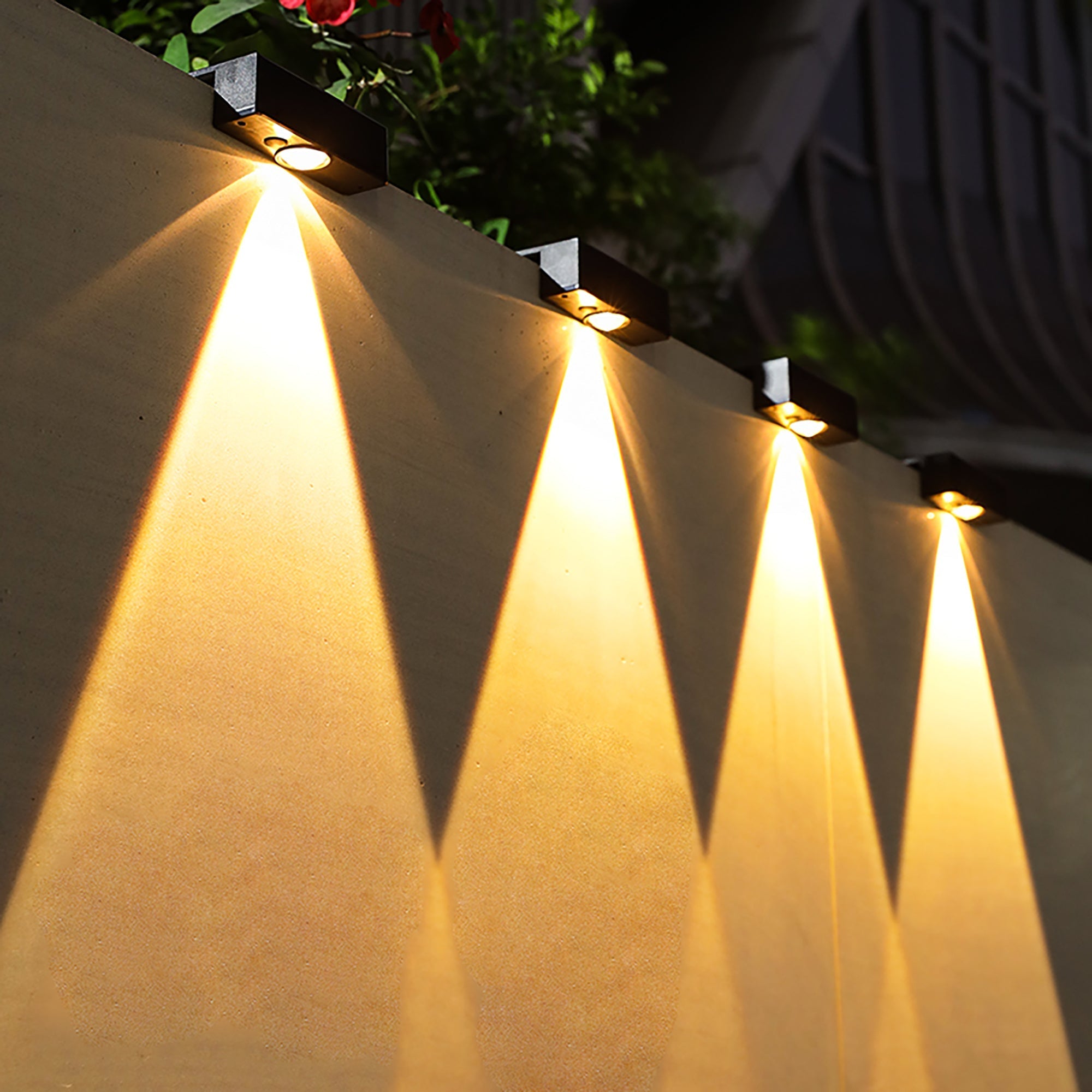 Solar Powered Outdoor Landscape Wall Lights illuminating a garden wall with warm, adjustable light, no wiring needed.