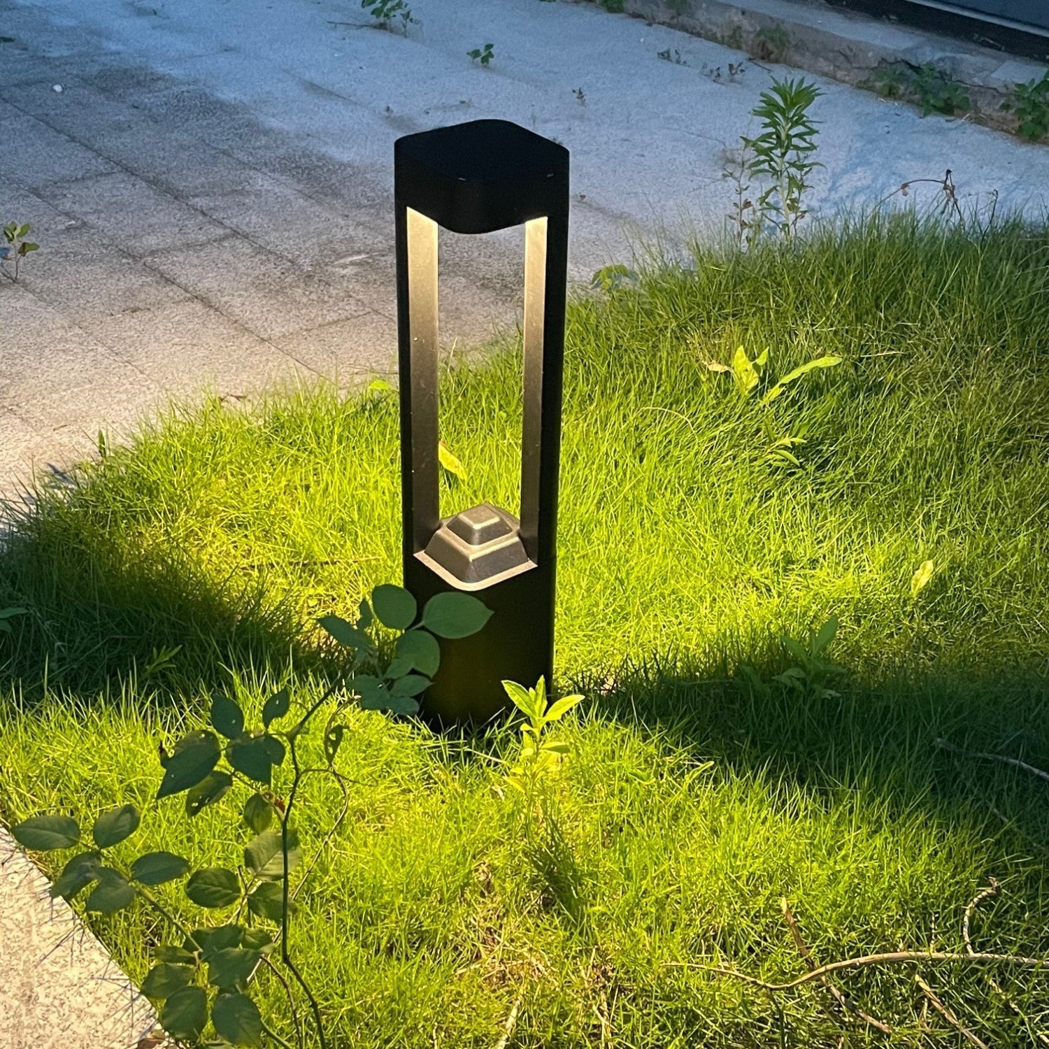 Solar Powered Outdoor Landscaping Path Lights illuminating a garden pathway with warm, eco-friendly glow at night.