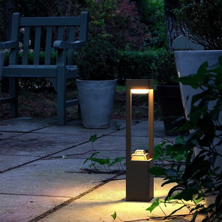 Solar Powered Outdoor Landscaping Path Lights illuminating garden pathway with warm, eco-friendly glow at dusk.