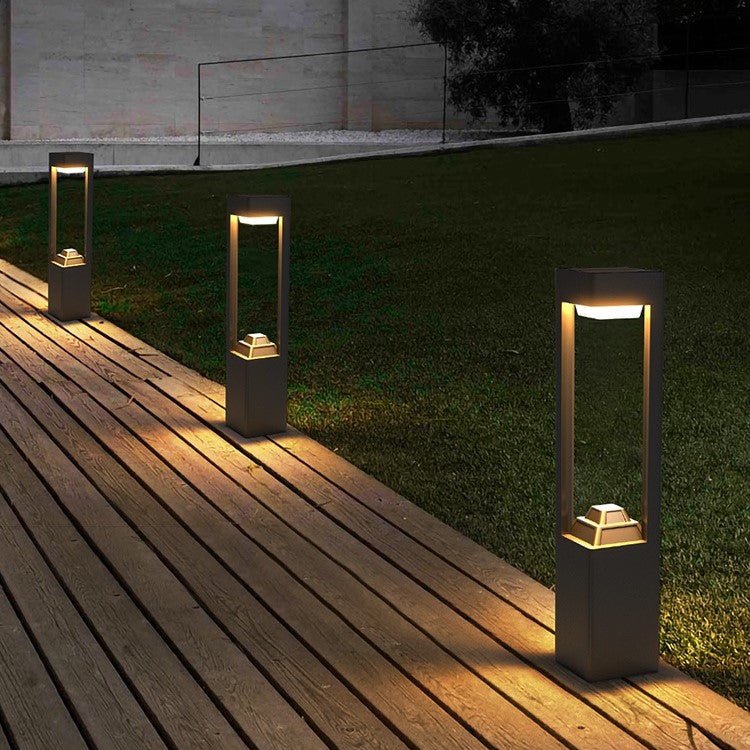 Solar Powered Outdoor Landscaping Path Lights illuminating a wooden deck with warm, eco-friendly, durable design at night.
