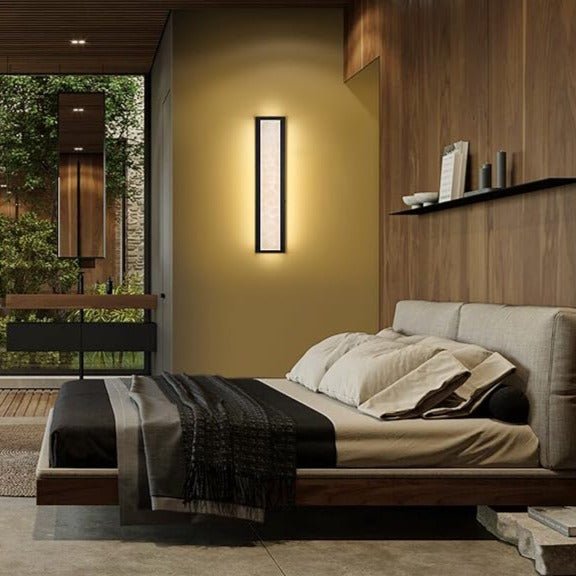 Waterproof Marble Front Porch Light Exterior Wall Sconce glowing warmly on a modern bedroom wall.