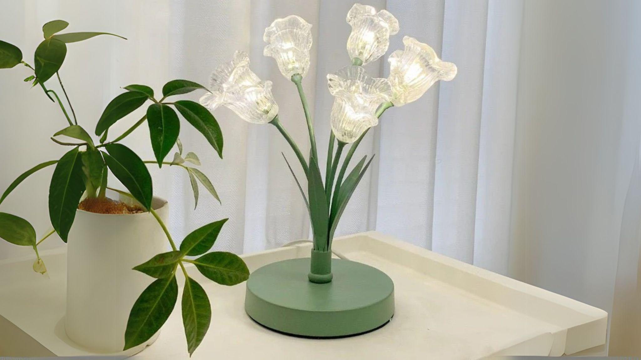 Floral Glass Lamp with delicate glass orchid shades on green iron base, offering elegant and natural indoor lighting.