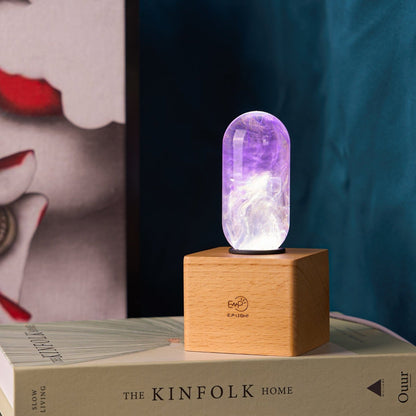 EP Light - Amethyst handcrafted eco-resin bulb glowing purple with unique patterns on wooden base.