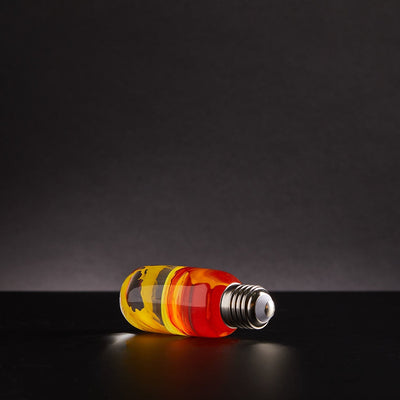 EP Light - Flame bulb glowing with warm amber tones in a handcrafted, eco-resin design for unique ambiance.