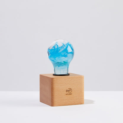 EP Light - Memory bulb with unique blue swirl design on vintage wooden base, energy-saving and handcrafted for expressive decor.