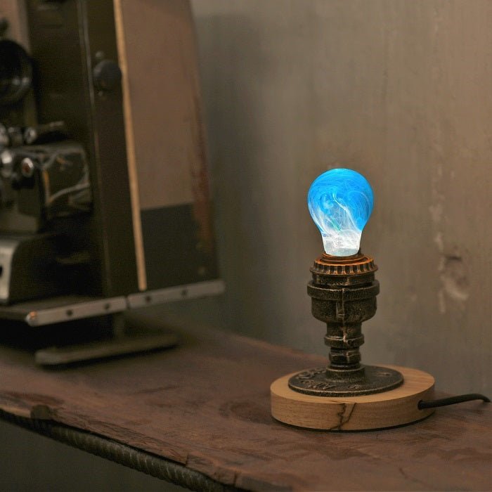EP Light - Memory bulb with unique blue swirl glow, eco-resin design, vintage wooden base, and energy-saving LED technology.