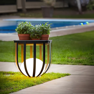 Outdoor Solar Power LED Plant Stand glowing outdoors with potted plants, illuminating garden pathway at night.