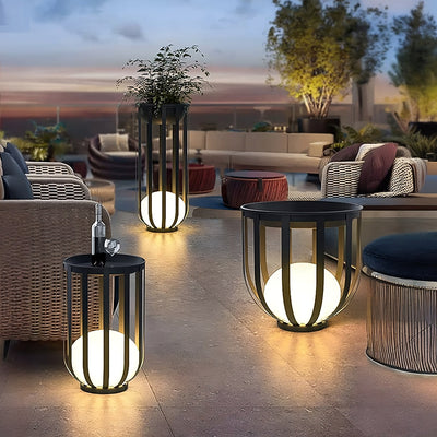 Outdoor Solar Power LED Plant Stand illuminating a stylish outdoor patio with warm solar lighting and plant display.