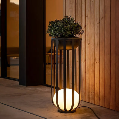 Outdoor Solar Power LED Plant Stand illuminating patio with warm light, stylish and functional solar-powered plant display.