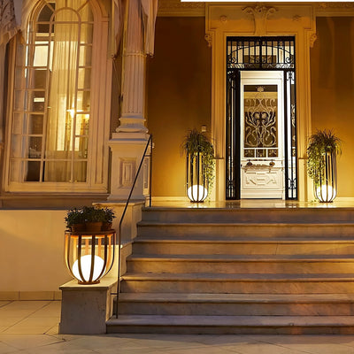 Outdoor Solar Power LED Plant Stand illuminating plants on elegant porch steps with warm solar light.