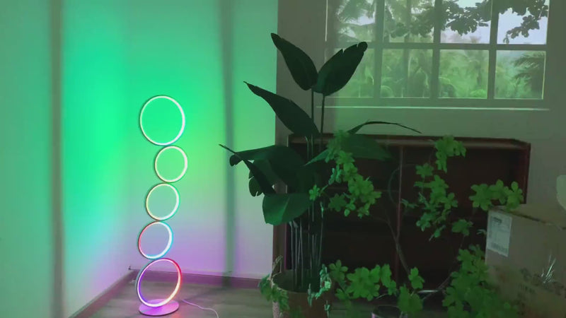 RGB circle floor lamp with glowing ring design and multicolor lighting, placed in a modern interior for ambient mood lighting