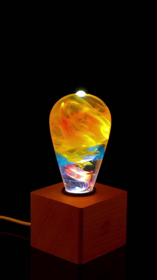 Load video: EP Light - Garden glows with vibrant, unique eco-resin patterns, combining energy-saving LED brilliance and natural beauty.